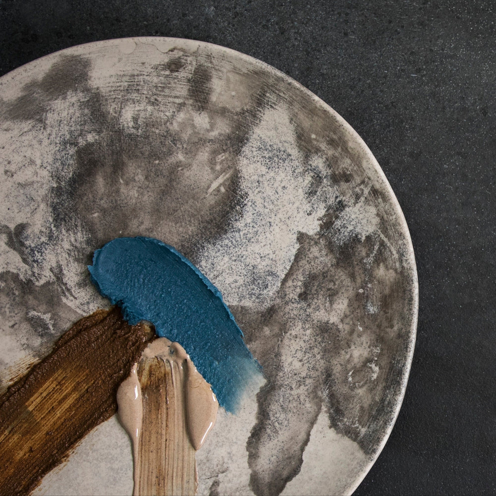 blue product texture on a round stone surface against a dark background