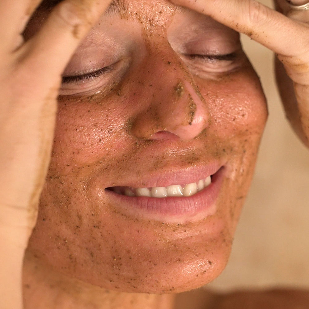 Close-up of a person applying a facial scrub
