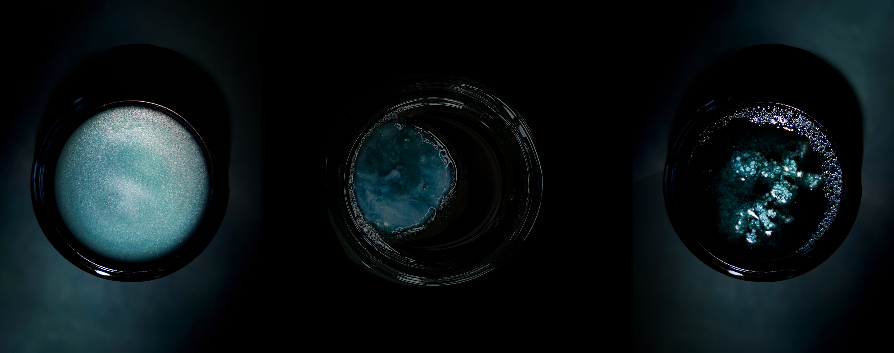 Three black bowls with blue contents at different stages of melting on a dark background
